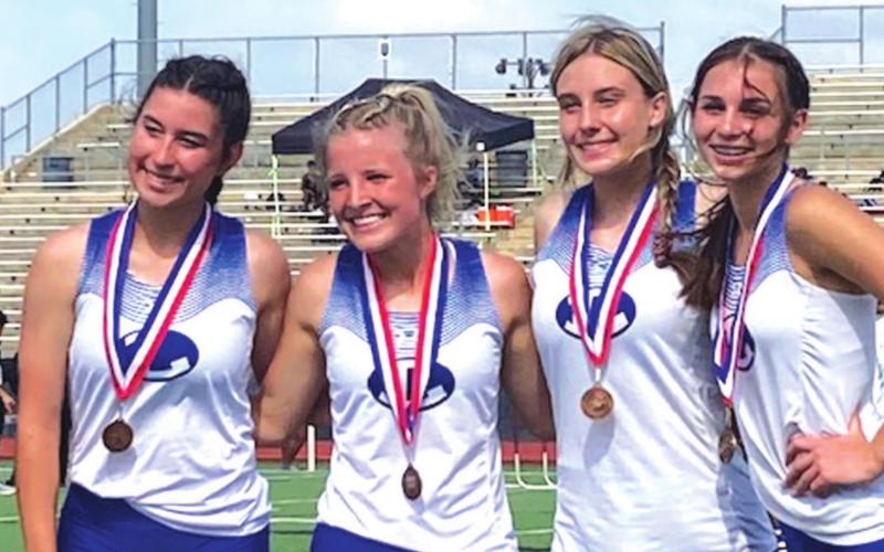 Gracie Ullevig, left, Morgan Myers, Cobie Chandler and Landry White pose for a photo after finishing fourth in the 4x200-meter relay. COURTESY PHOTO
