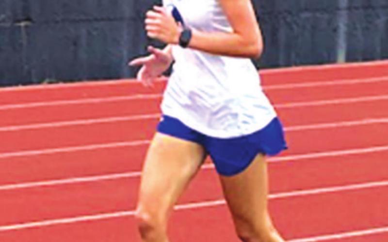 Nyla Long rounds the corner during her 3200-meter run. COURTESY PHOTO