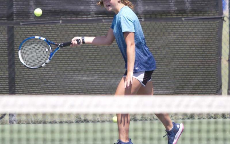 Abby Valdez prepares to hit a return shot during last week’s tennis practice. HUNTER KING | DISPATCH RECORD
