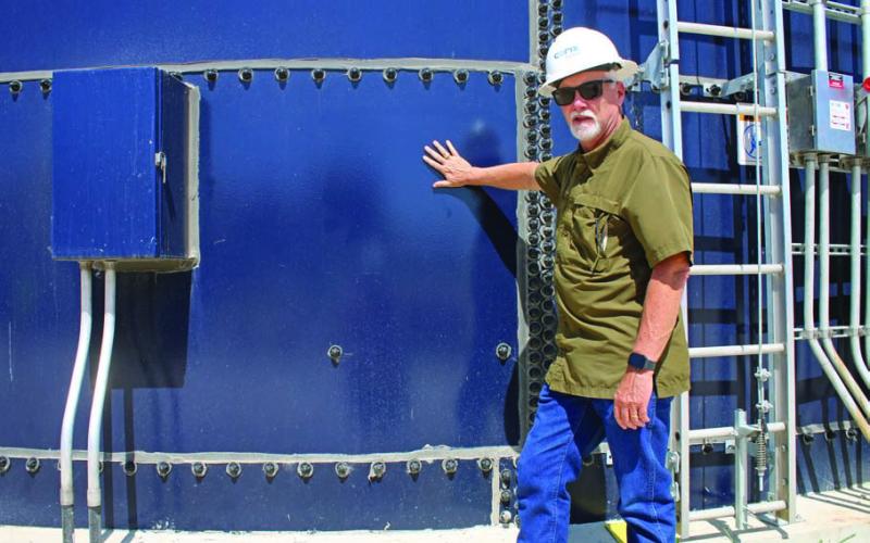 Darrin Barker highlights the use of Corix’s “clear well,” a glass-insulated container that stores clean, filtered water at the plant. MASON HINES | DISPATCH RECORD