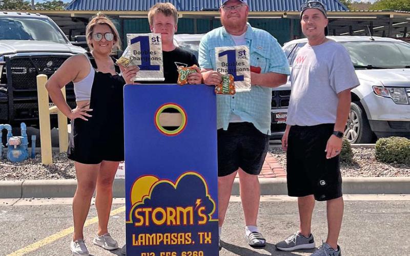 Cayhil Isom and Trampus Isom won first place at the Murray Events Cornhole Tournament. They are pictured here with event organizers Val Sanchez, left, and Kenny Murray, right. The tournament took place at Storm’s Drive-In restaurant and offered a 50/50 split between winners and to benefit the St. Mary Catholic Church food pantry and kitchen. Event proceeds will help to feed families in need during the holidays and year-round. courtesy photo