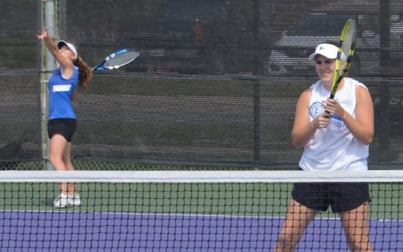 Abby Valdez serves while Kailr Clements stands ready near the net on Monday, the first of a several-day district tennis tournament in Stephenville. KENNETH PEISER | COURTESY PHOTO