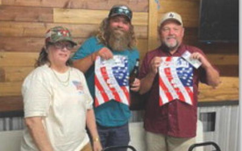 courtesy photo Darlene Johnson, 42 tournament coordinator, is shown with the second-place team, Pepper Isom, center, and Jim Lindeman.