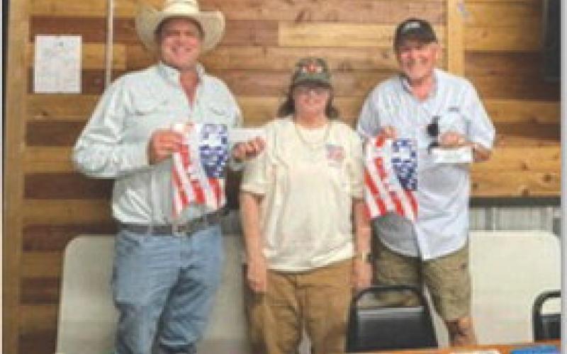 courtesy photo John Osgood, at left, and Deorald Finney, at right, took third place in the Spring Ho 42 Tournament. Darlene Johnson was on hand to present their winnings.