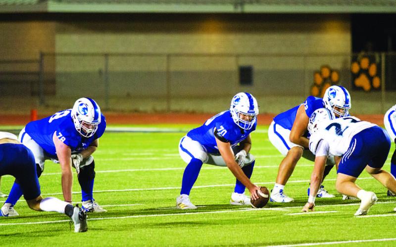 Jeremiah Peters prepares to snap the ball in the second-round playoff game in Snyder. HUNTER KING | DISPATCH RECORD
