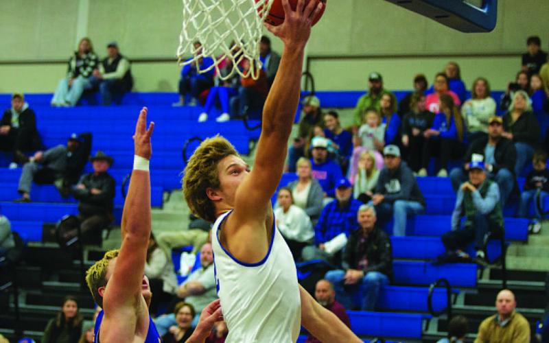 Haegan Oncken lays a ball off the backboard for two points on the fast break against Blanco. HUNTER KING | DISPATCH RECORD