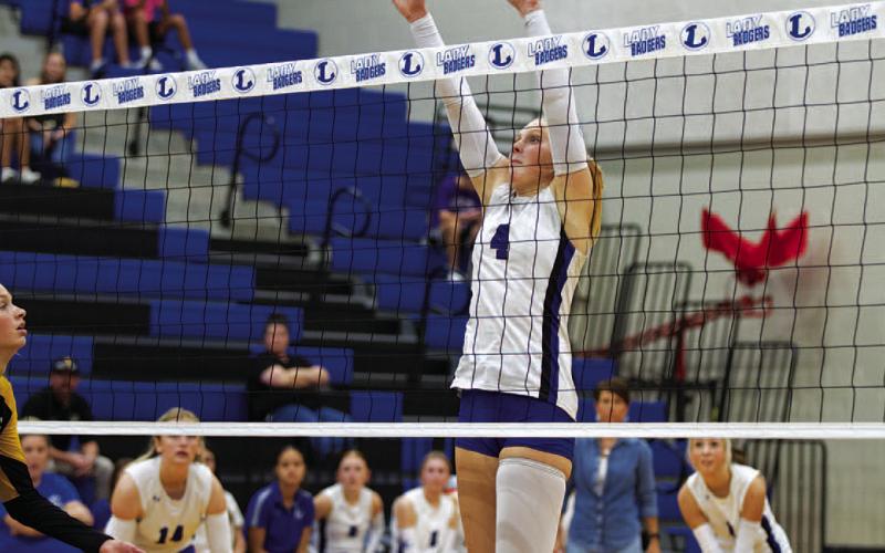 Brylie Turner leaps for a block during Tuesday’s match against the Lady Hornets. She also led the team in kills. HUNTER KING | DISPATCH RECORD