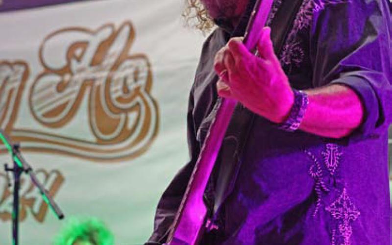 joycesarah mccabe | dispatch record Duane Propes of the band Little Texas delivers a powerful bass performance at Spring Ho 2024, thrilling the street dance crowd with his energetic stage presence.