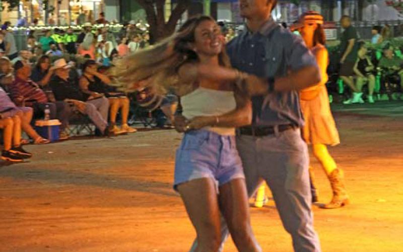 joycesarah mccabe | dispatch record This couple spin and dance Friday night, keeping perfect time with the music being played from the stage at this year’s Spring Ho Street Dance on the Square.