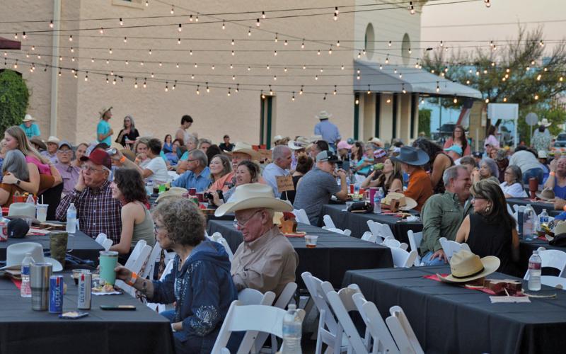 Western Night on Western attendees enjoy a bite to eat before Jake Hooker and the Outsiders take the stage. erick mitchell | dispatch record