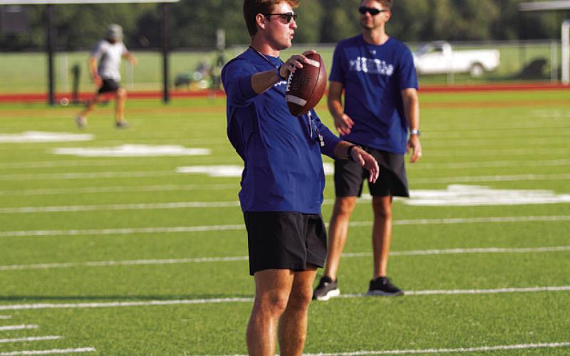 Assistant football coach Hadley Berry works with receivers at football camp. HUNTER KING | DISPATCH RECORD
