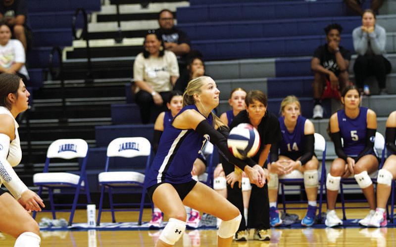 HUNTER KING | DISPATCH RECORD Brailey Wilson makes a pass as head coach Christy Wiley watches on from the bench.