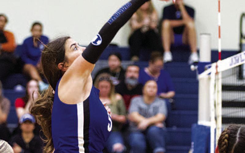 HUNTER KING | DISPATCH RECORD Ysa Swain swings through an attempted kill against Jarrell.