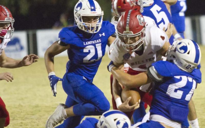 Peyton Underwood (4), Aden Rascoe (27) and Ethan Moreno (21) make a tackle in the last regularseason game on Friday at Badger Field. JEFF LOWE | DISPATCH RECORD