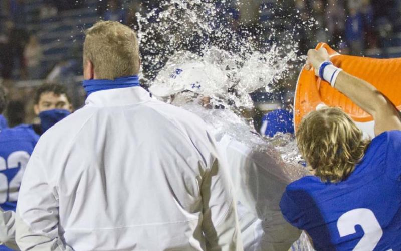 Quarterback Ace Whitehead (2) dumps a Gatorade cooler on head coach Troy Rogers (back-center of photo. Also pictured is Offensive Coordinator Heath Naragon (facing away from camera). JEFF LOWE | DISPATCH RECORD
