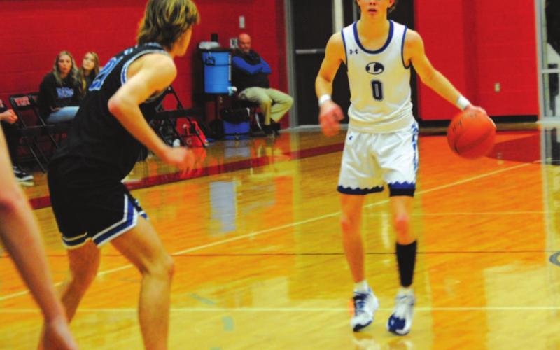 Nate Borchardt sizes up a Decatur defender during the Badgers’ playoff game. HUNTER KING | DISPATCH RECORD