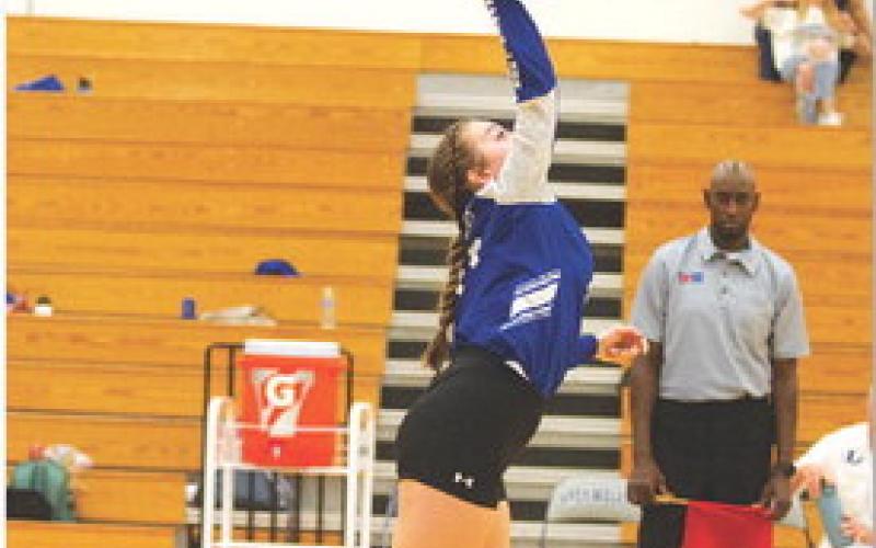 Abbey Green hits a serve for the Lady Badgers. HUNTER KING | DISPATCH RECORD
