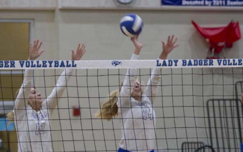 Maggie Fletcher, left, and Madison Roedler go up for a block during the match against Brownwood. HUNTER KING | DISPATCH RECORD