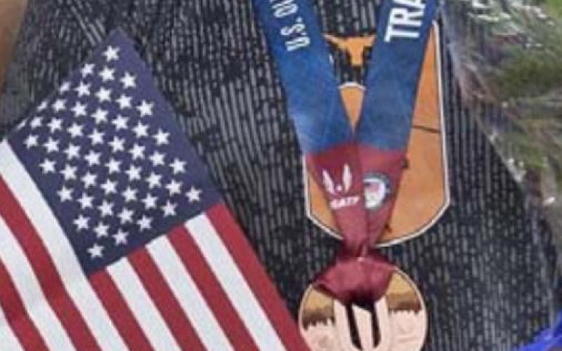 Steffin McCarter is shown with the American flag and his bronze medal at the Olympic Trials in Eugene, Oregon, last weekend. COURTESY PHOTO