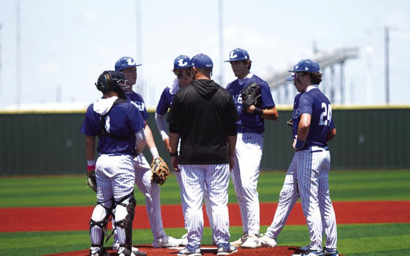 The Badger infield comes together for a meeting in game two against China Spring. HUNTER KING | DISPATCH RECORD