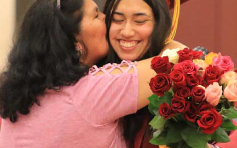 Edna “Momo” Torres embraces granddaughter and graduate Mia Crain during the Class of 2024’s presentation of roses. mason hines | dispatch record