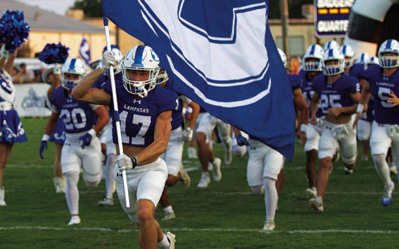 HUNTER KING | DISPATCH RECORD Sean Smith leads the Badgers onto the field before every game.