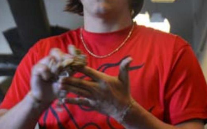 Lampasas High School senior Cohen White washes his hands before working on an engine. He has been accepted to a highly competitive automotive technical school in Sealy. MONIQUE BRAND | DISPATCH RECORD