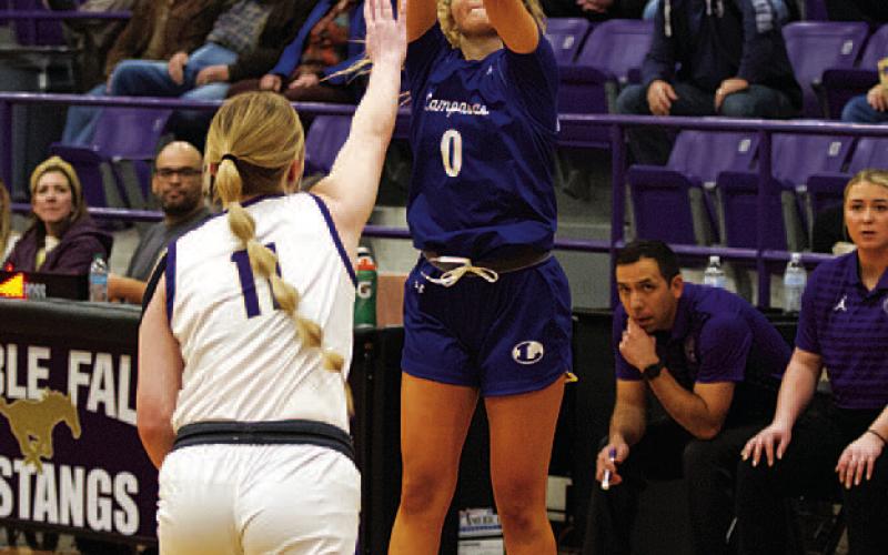 HUNTER KING | DISPATCH RECORD Addison Borchardt shoots a three-point shot over a reaching defender.