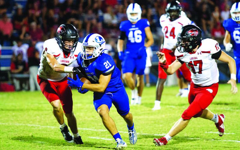 HUNTER KING | DISPATCH RECORD KJ Reed runs past Leopard defenders during the Badgers’ win last week.