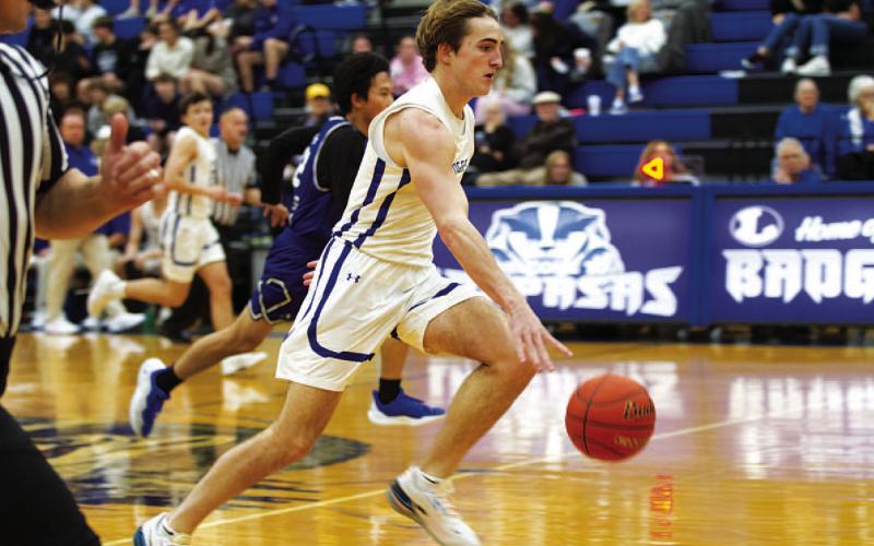 Bryson Roberts dribbles toward the basketball after coming up with a steal against Jarrell. HUNTER KING | DISPATCH RECORD