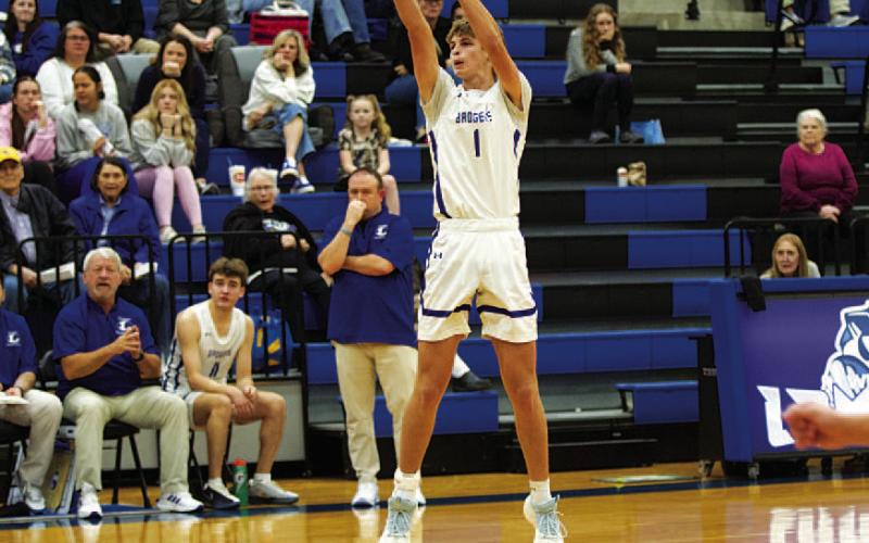 Vince Shahan releases a three-point shot in the second half of the victory. HUNTER KING | DISPATCH RECORD
