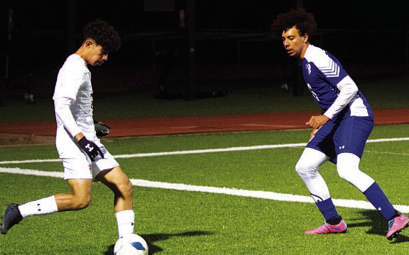 Tyler Grant defends on the wing during the first half of the contest. HUNTER KING | DISPATCH RECORD