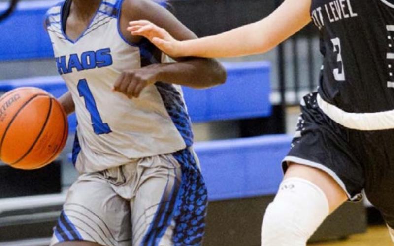 Nattie Martin dribbles past a defender in Lampasas’ last game on Monday night in the Hill Country Hoops League. JEFF LOWE | DISPATCH RECORD