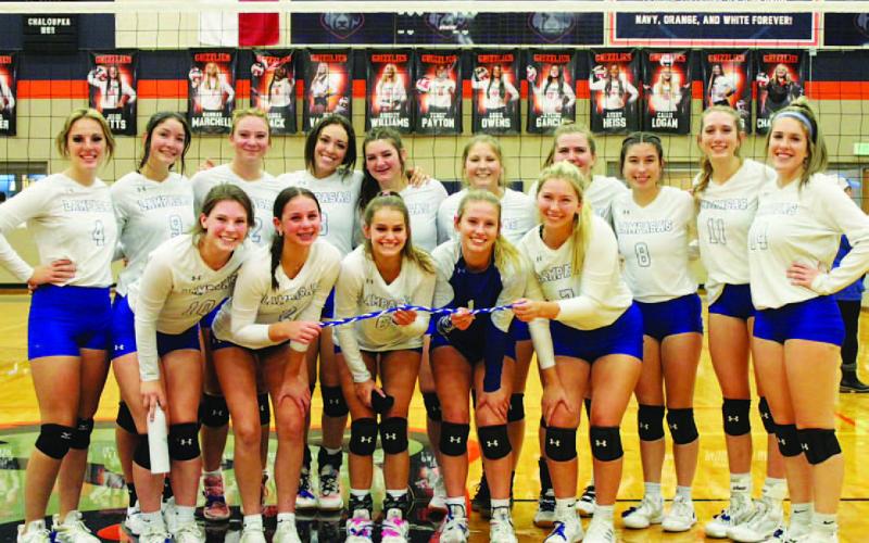 COURTESY PHOTO The volleyball team smiles after their play-in game win over Jarrell. They are headed to the playoffs.