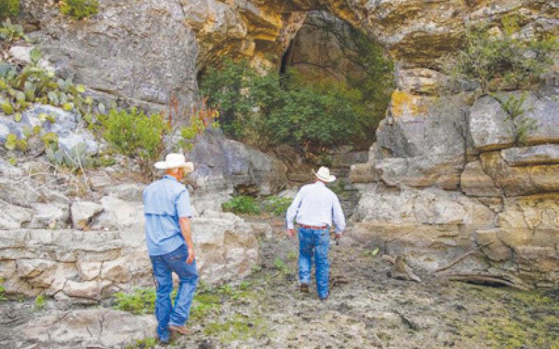 chris miles | dispatch record Robby Vann and Sam Middleton explore one of the natural arches on Pillar Bluff Ranch.