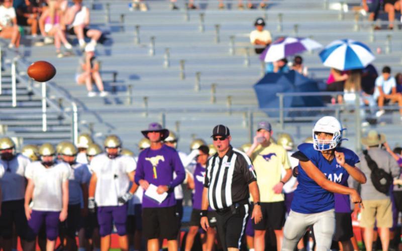 Dylan Sanchez throws a pass during a scrimmage against Marble Falls at the beginning of last season. The Badgers and Mustangs will compete in District 13-4A in the fall. FILE PHOTO