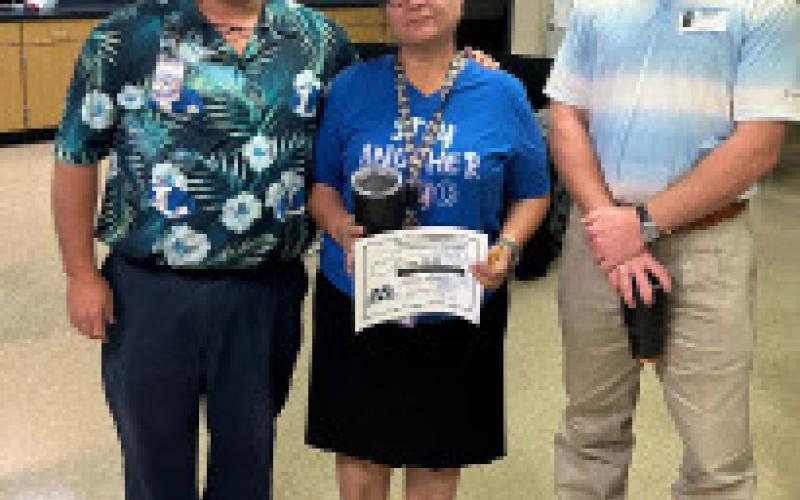 Norma Rude was named Support Staff Member for August at the high school. She is presented her certificate by Lampasas High School Assistant Principal Ryan Race, at left, and Texas Farm Bureau’s Clay Phillips. Courtesy PHOTO