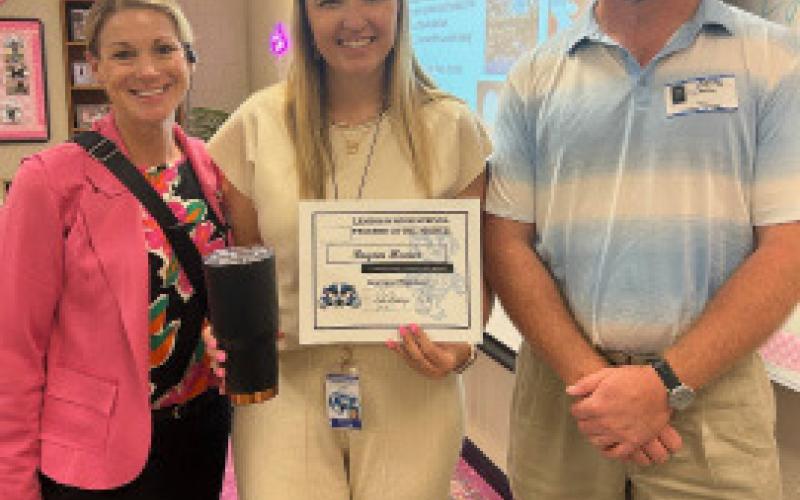 First-year culinary teacher and cheer coach Brynn Huner holds her Teacherof- the-Month certificate alongside LHS Assistant Principal Kristin Montague, at left, and Clay Phillips. Not pictured: Becky Bolinger, who was named Substitute of the Month for August. Courtesy PHOTO