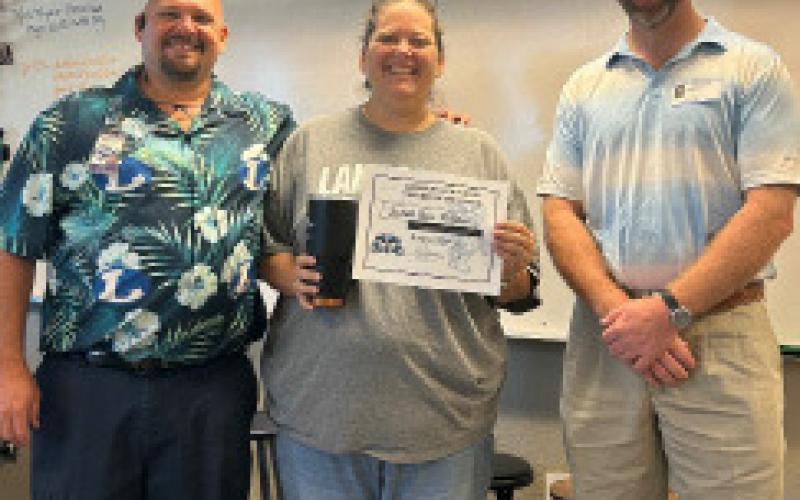 English teacher and UIL Academics/ speech and debate coordinater Judith Ann McGhee also was named Teacher of the Month for August. Joining her are Assistant Principal Ryan Race, left, and Clay Phillips of Texas Farm Bureau Insurance. Courtesy PHOTO
