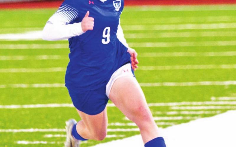 Bella Lindsey dribbles down the field during a match in her freshman season. FILE PHOTO