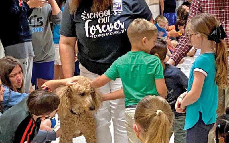 courtesy photo Tayt was a beloved campus dog at Taylor Creek Elementary School who retired in 2021 along with principal Renee Cummings.