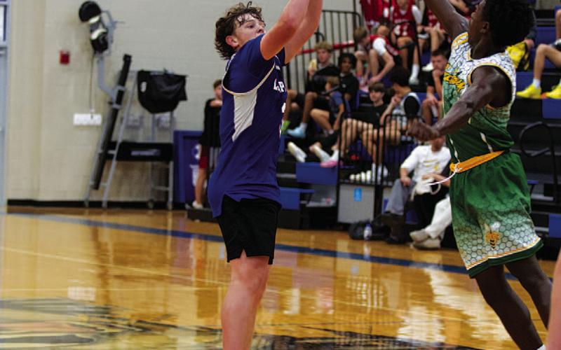 Aidan Nuckles shoots over the outstretched hand of a defender. HUNTER KING | DISPATCH RECORD