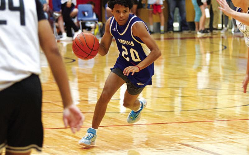 Angel Scott dribbles past a defender during the summer league. HUNTER KING | DISPATCH RECORD