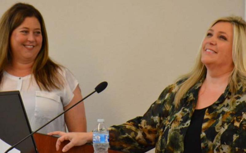 Outgoing Lampasas City Councilwoman Delana Toups, left, and outgoing mayor Misti Talbert share a laugh Monday during the city’s presentation about their combined 11 years of service. MONIQUE BRAND | DISPATCH RECORD