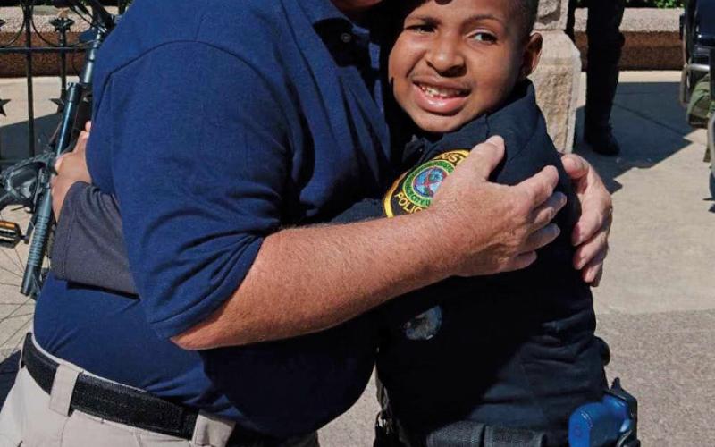Paul Miceli embraces Devarjaye “DJ” Daniel at Daniel’s honorary swearing-in at the Texas Capitol. erick mitchell | dispatch Record