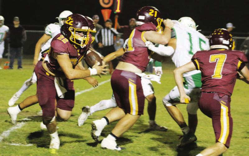 Lukas Smailus-Cruz looks for running room while Roy Carr (21) and Easton Hamilton (7) block. Smailus-Cruz rushed for three touchdowns in the game. MASON HINES | DISPATCH RECORD