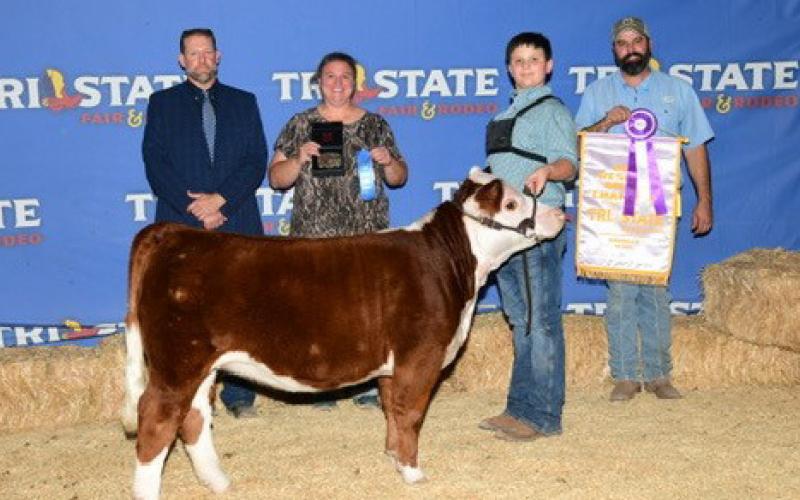 Cort Maples poses for a photo with his miniature Hereford after being named Grand Champion Junior Showman at the Tri State Fair in Amarillo. Courtesy photo