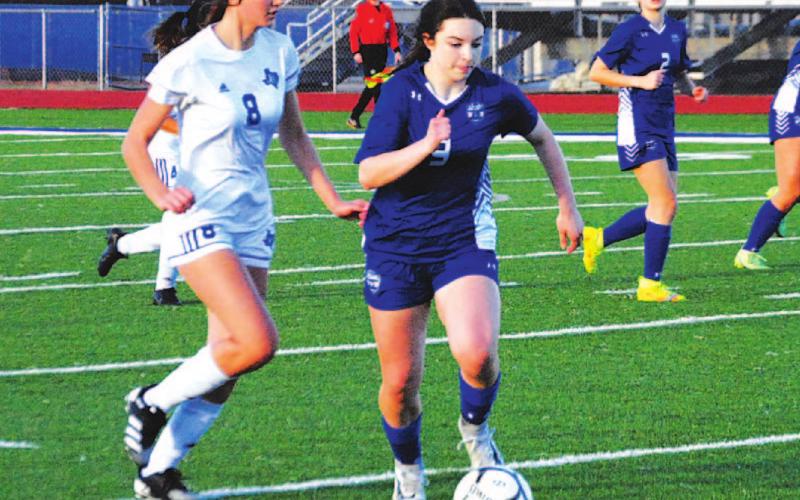 Bella Lindsey dribbles past Jarrell defenders during a district game in the 2022 season, her sophomore campaign. FILE PHOTO