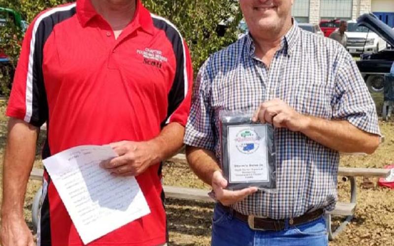 Scott Carrigan, left, presented Storm’s Drive-In owner Mike Green a plaque on Sept. 11 to thank him for 15 years of hosting the Classics at the Classic events. COURTESY PHOTO