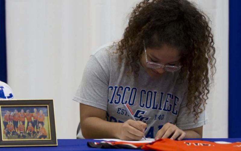 Alycia Cantu signs her letter of intent to play softball for Cisco College at the Lampasas High School gym on Wednesday. HUNTER KING | DISPATCH RECORD